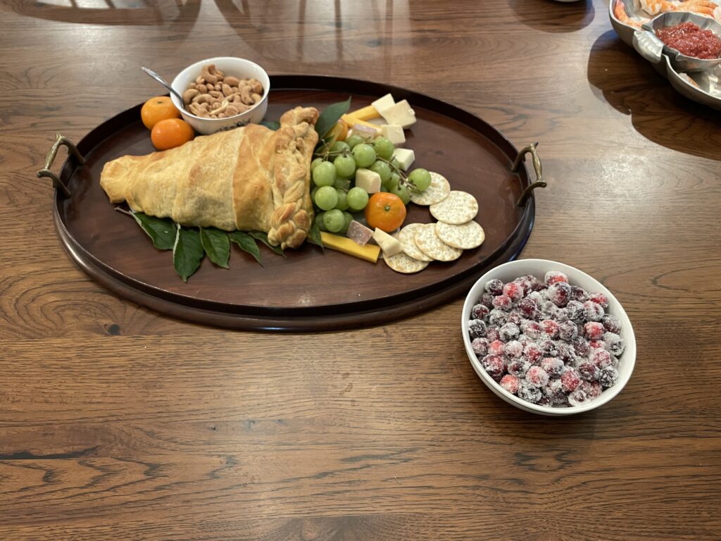 a cornucopia made of bread with fruit and crackers.